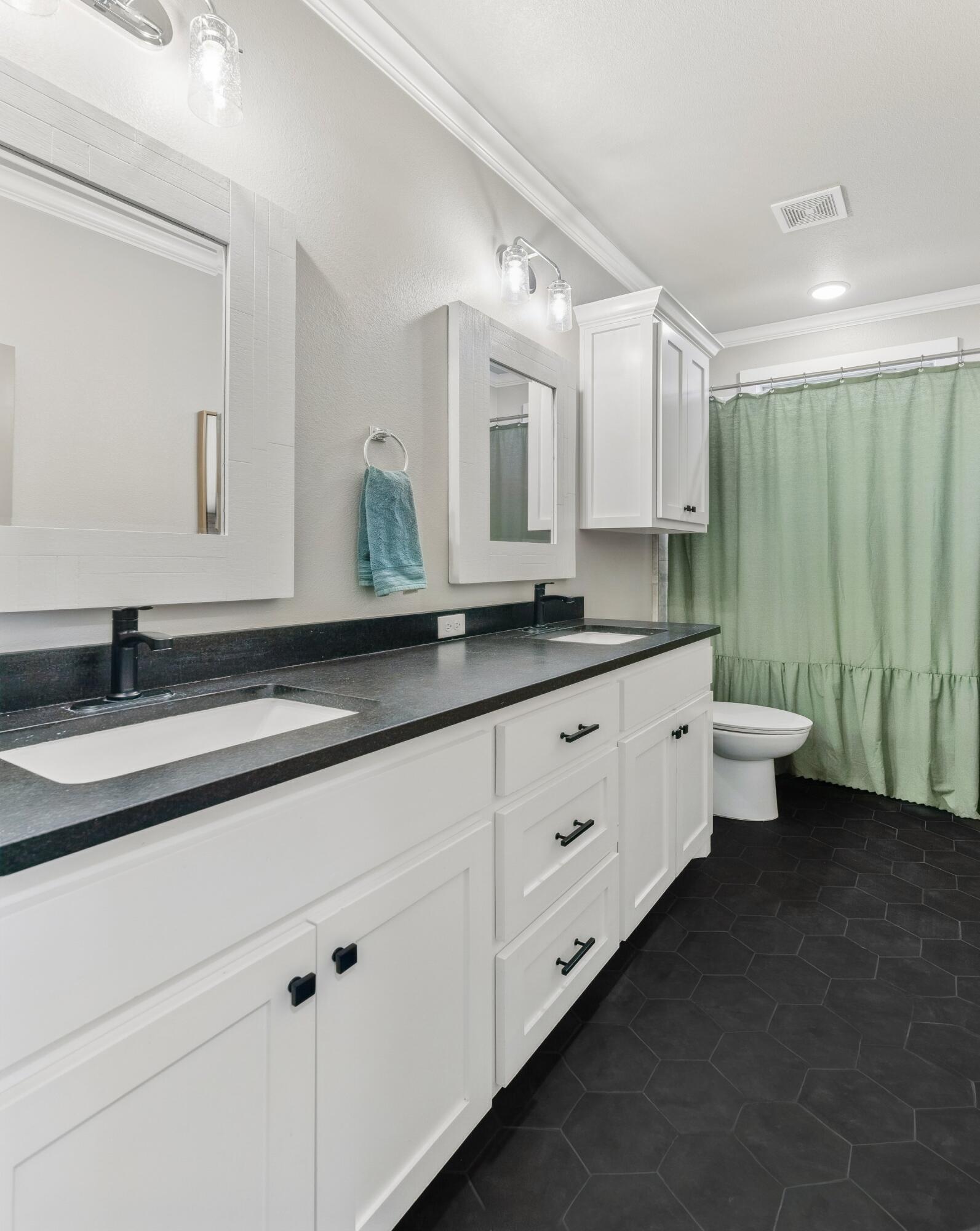 629 North 9th Street Wolfforth, TX 79382 - Photo 29 of 45 a spacious bathroom with a double vanity sink and a mirror