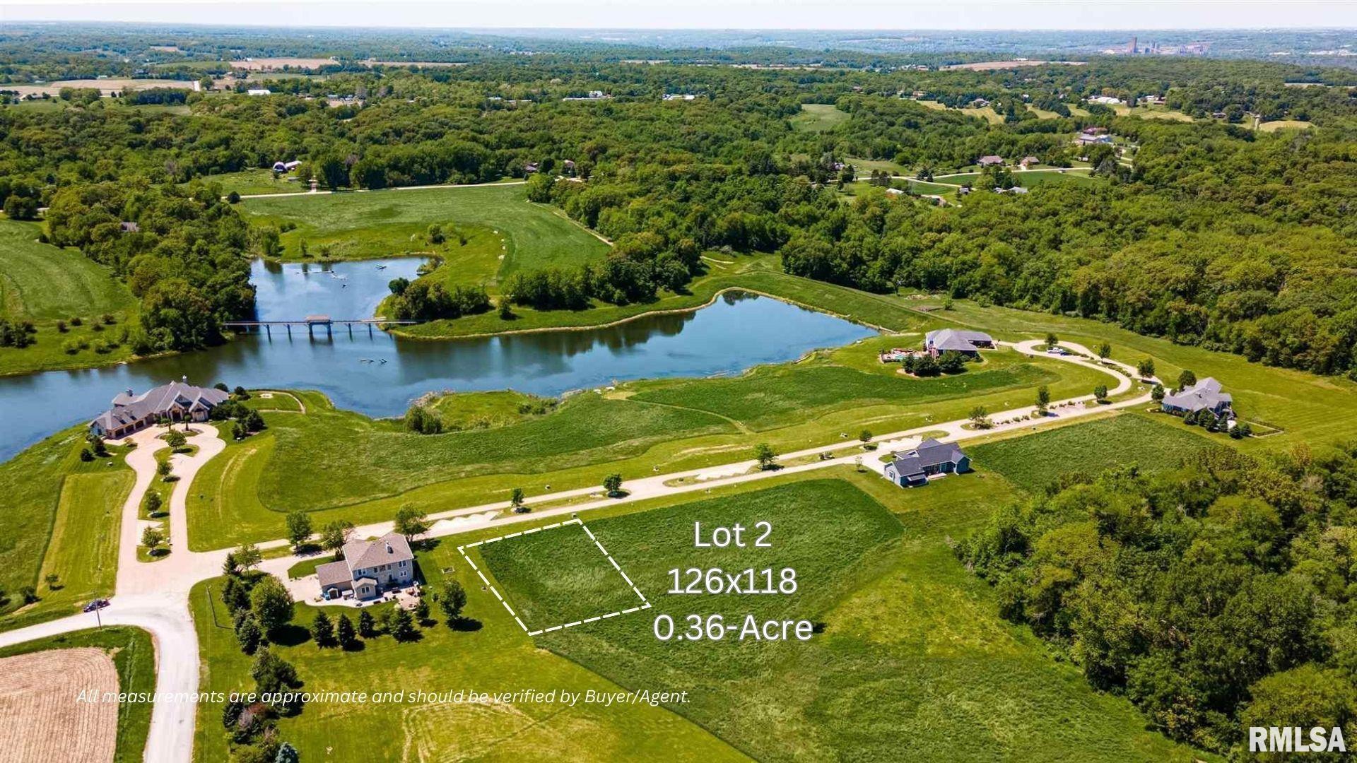 an aerial view of residential houses with outdoor space and parking