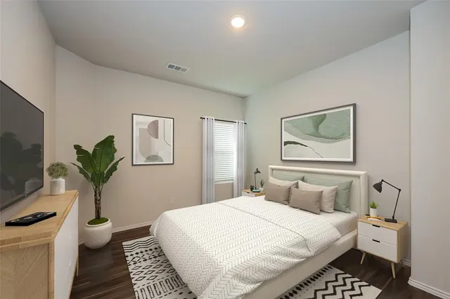 a bedroom with a bed and a flat screen tv