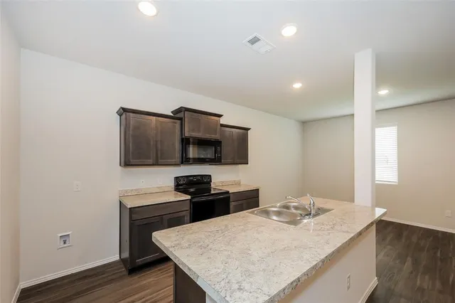 a kitchen with a sink and microwave