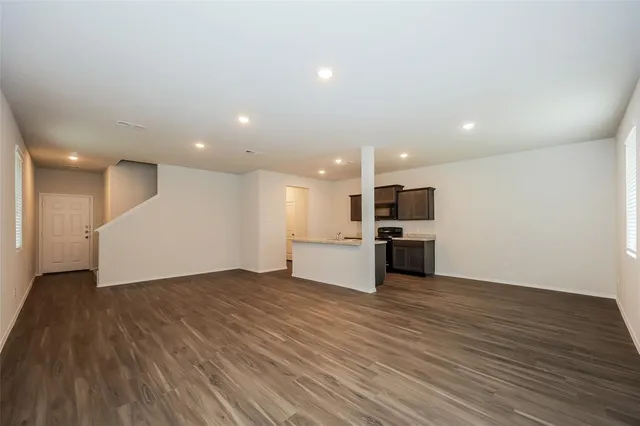 a view of kitchen with kitchen island and stainless steel appliances