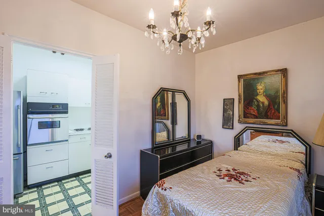 a bedroom with a bed and a chandelier