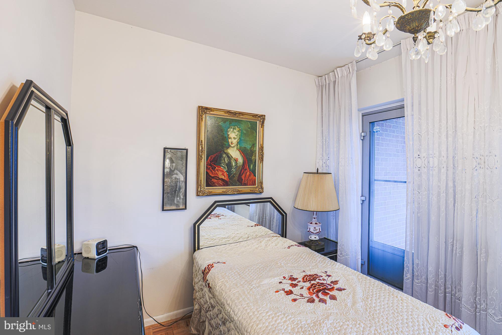 11 Slade, Unit 614 Pikesville, MD 21208 - Photo 16 of 38 a bed room with a bed and a lamp