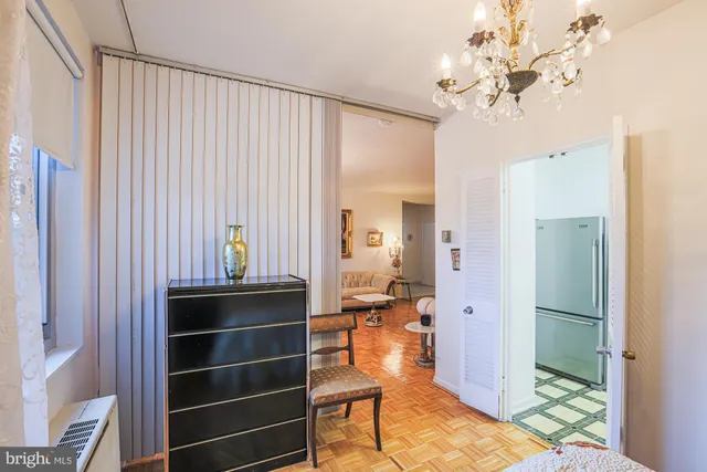 a kitchen with stainless steel appliances a stove a sink cabinets and a dining table