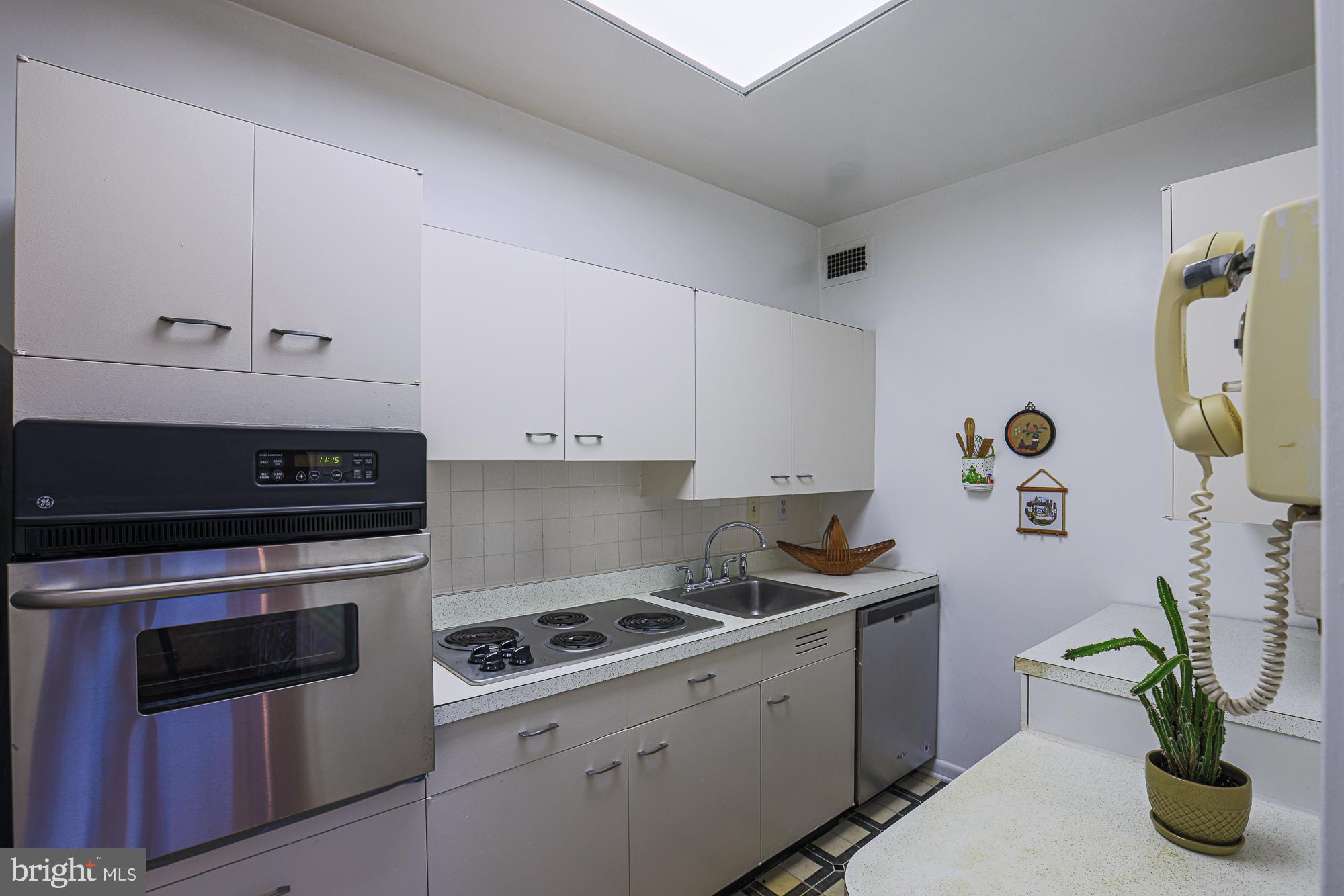 11 Slade, Unit 614 Pikesville, MD 21208 - Photo 19 of 38 a kitchen with a stove and a potted plant