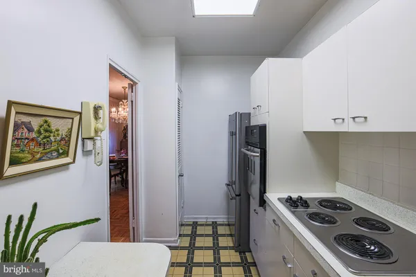 a kitchen with a refrigerator and a stove