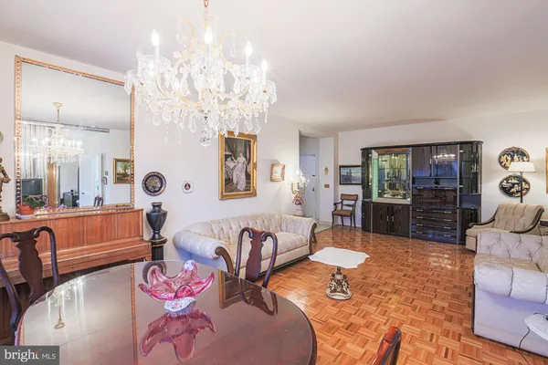 a living room with furniture and a chandelier