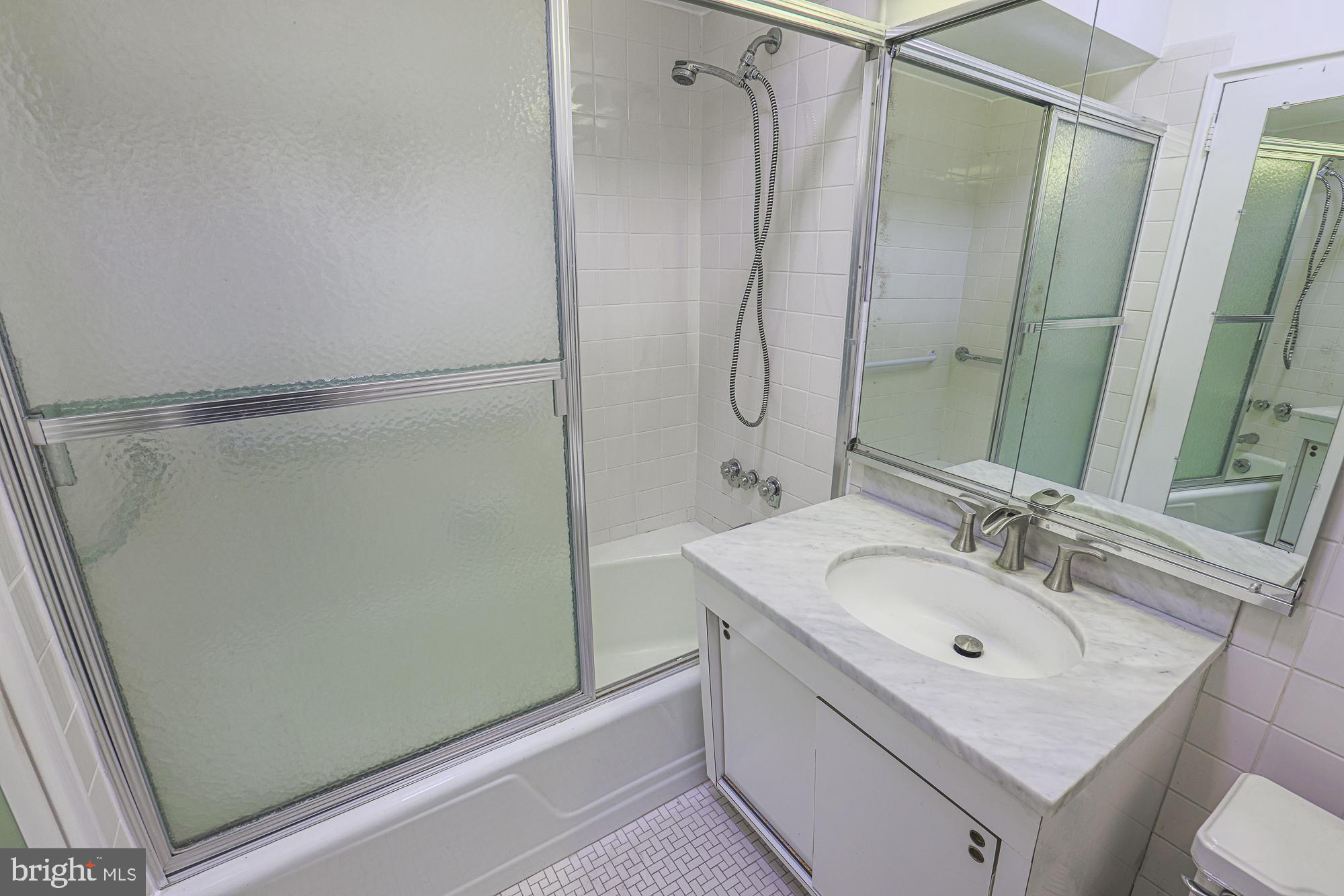 11 Slade, Unit 614 Pikesville, MD 21208 - Photo 24 of 38 a bathroom with a sink and a mirror