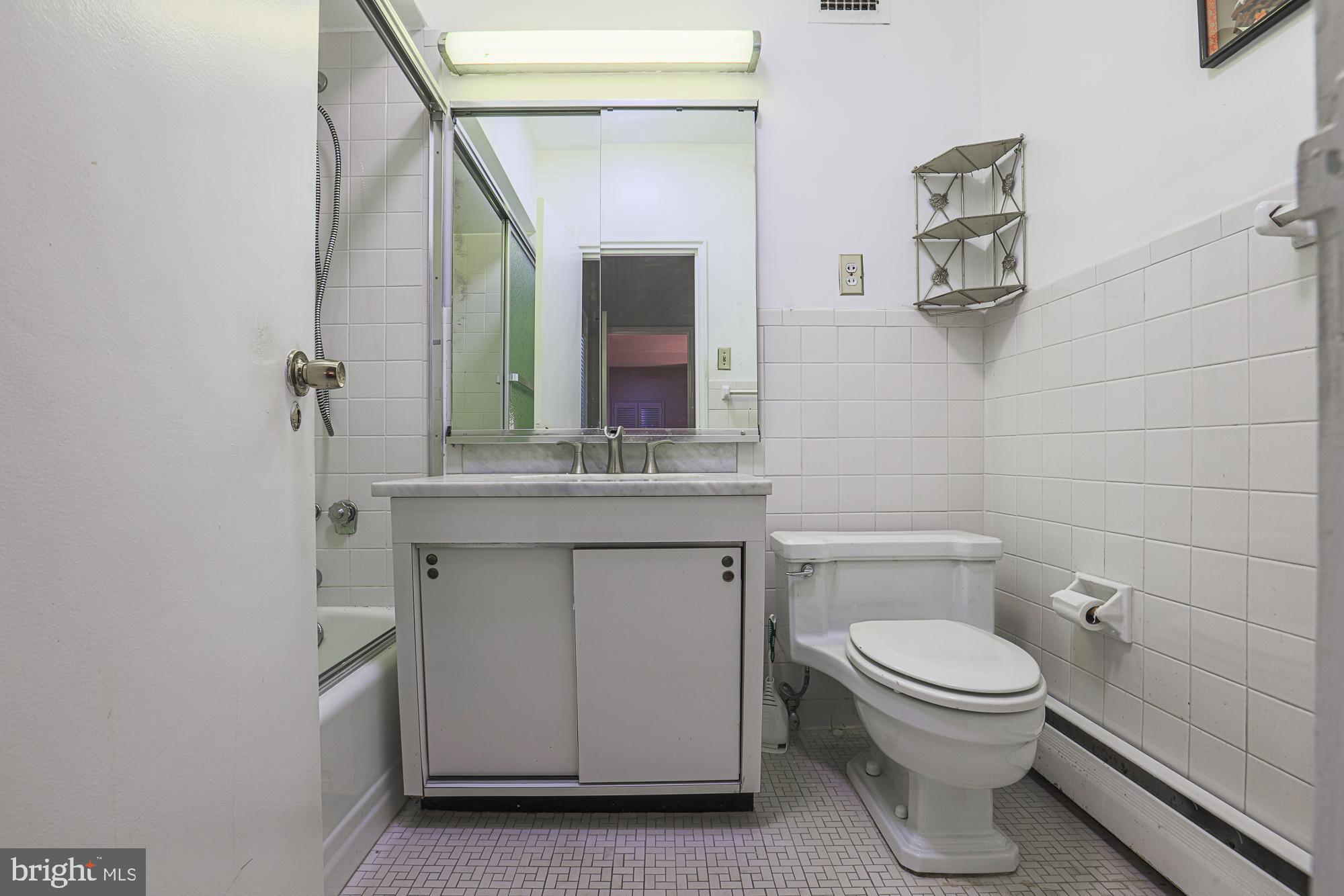 11 Slade, Unit 614 Pikesville, MD 21208 - Photo 25 of 38 a bathroom with a toilet sink and mirror