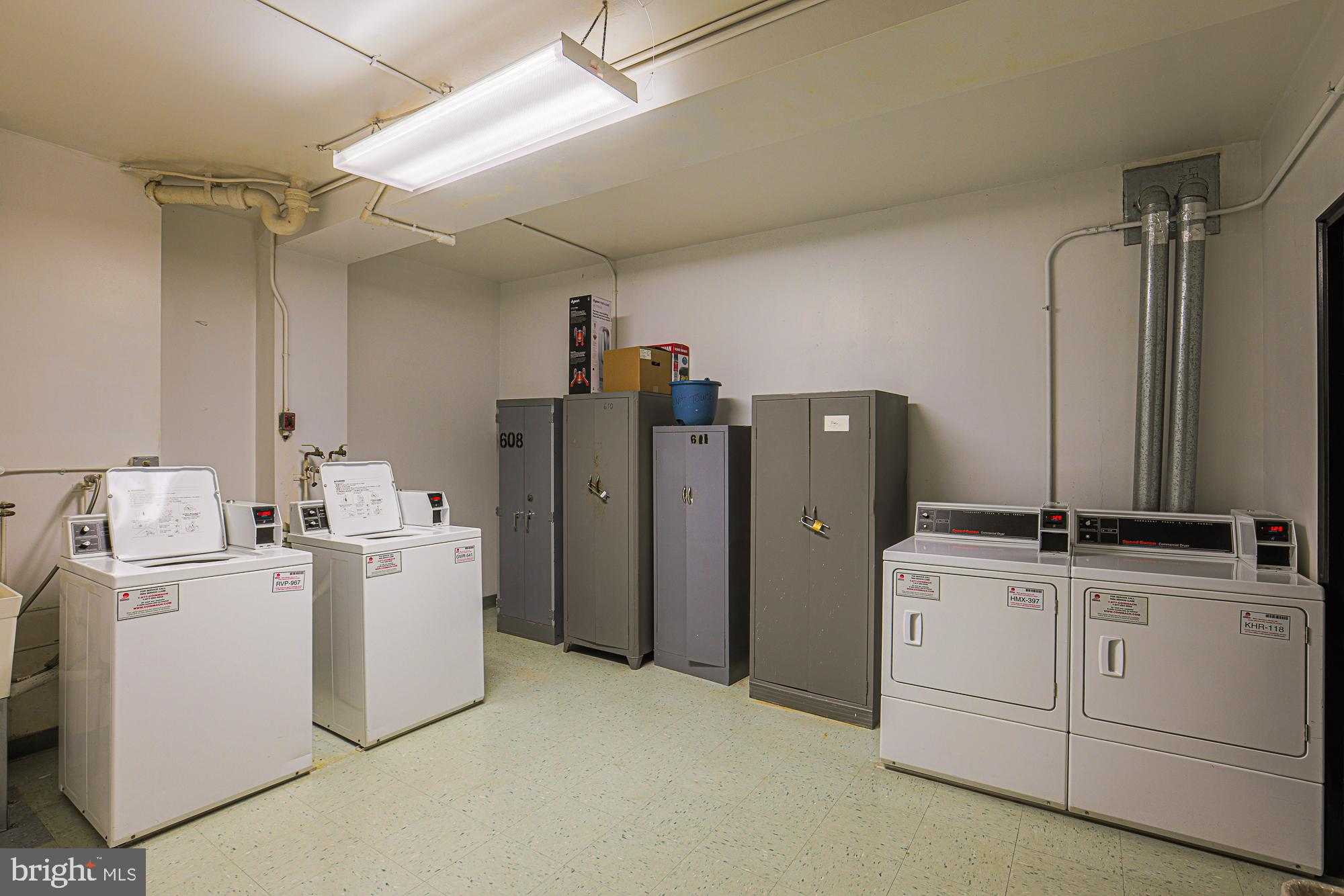 11 Slade, Unit 614 Pikesville, MD 21208 - Photo 29 of 38 a room with refrigerator and washer