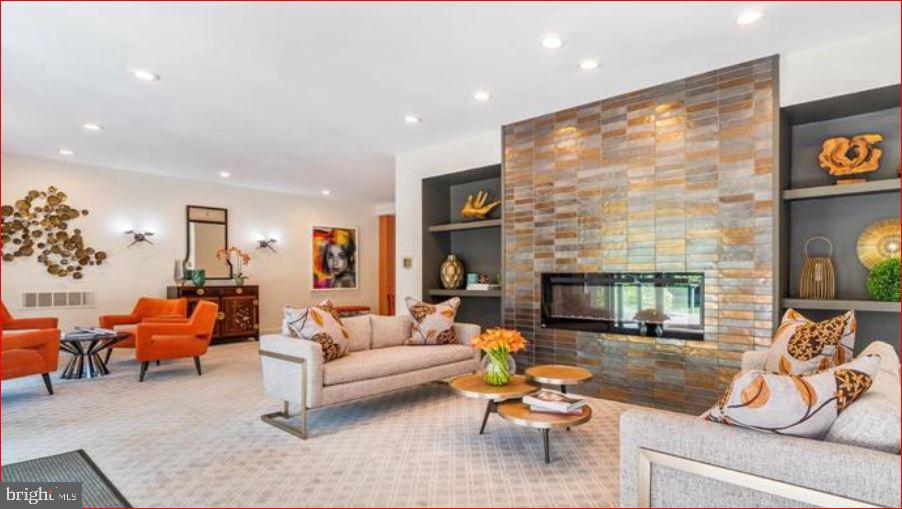 11 Slade, Unit 614 Pikesville, MD 21208 - Photo 34 of 38 a living room with patio furniture and a fireplace