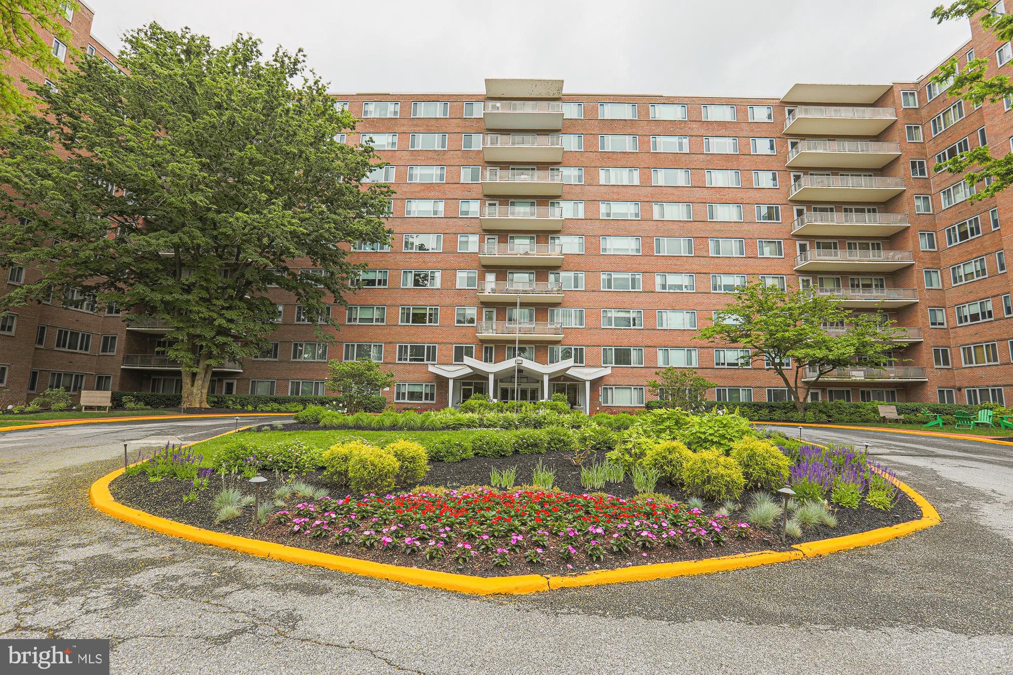 11 Slade, Unit 614 Pikesville, MD 21208 - Photo 4 of 38 a view of a swimming pool with a chair and tables in the patio