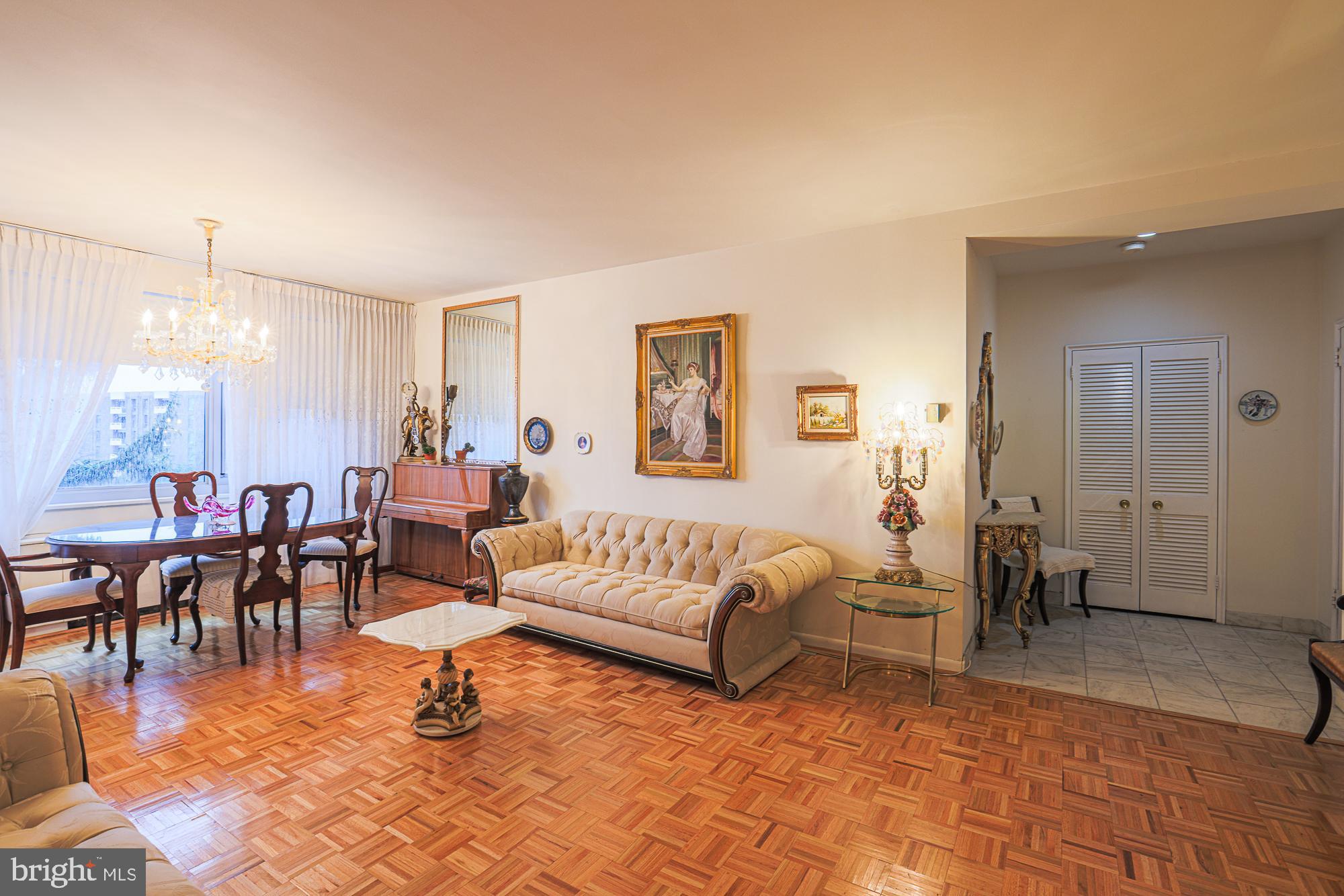 11 Slade, Unit 614 Pikesville, MD 21208 - Photo 8 of 38 a living room with furniture a dining table and a potted plant