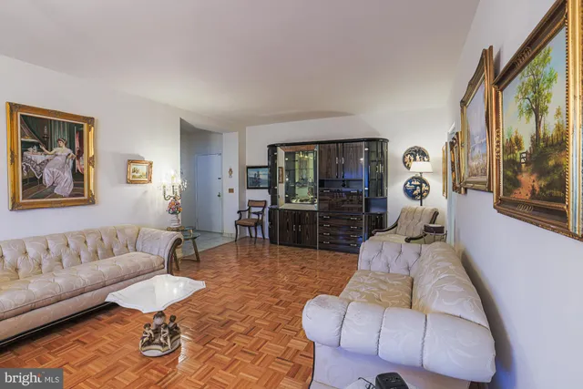 a living room with furniture and a chandelier