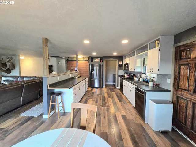 a large kitchen with lots of counter space and stainless steel appliances