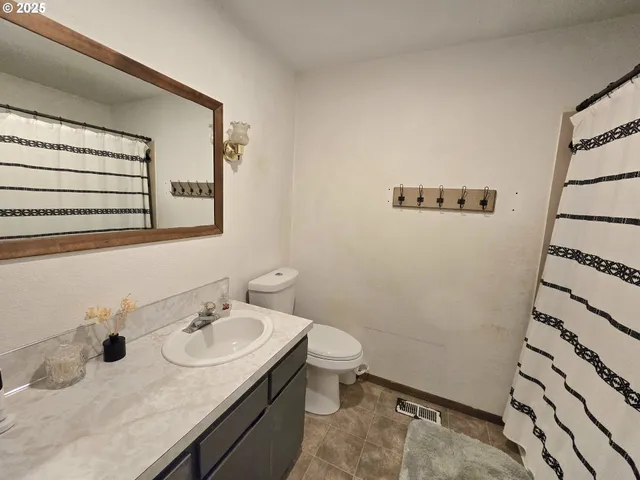 a bathroom with a sink toilet and mirror