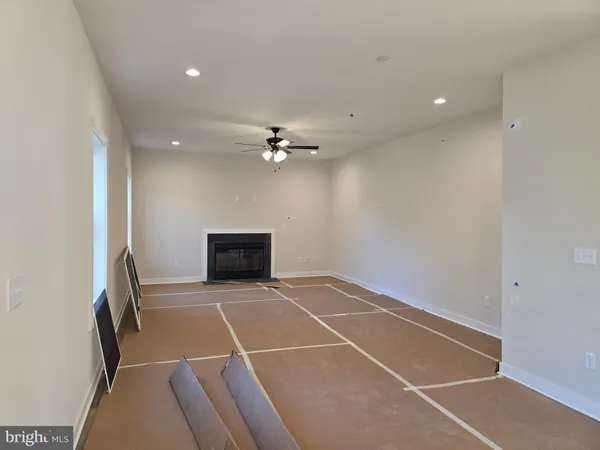 a view of a hallway with wooden floor and entryway