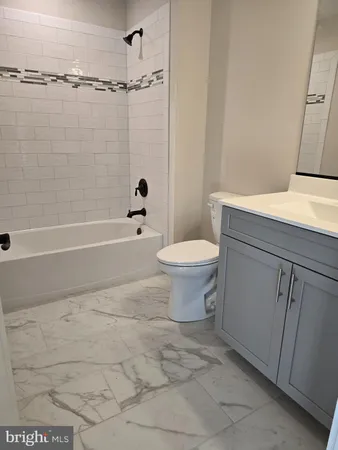 a view of empty room with wooden floor and fireplace