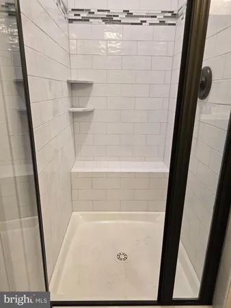a view of a kitchen with a sink and a chandelier fan