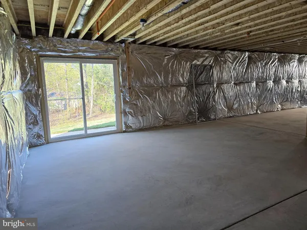 a kitchen with kitchen island granite countertop a sink cabinets and wooden floor