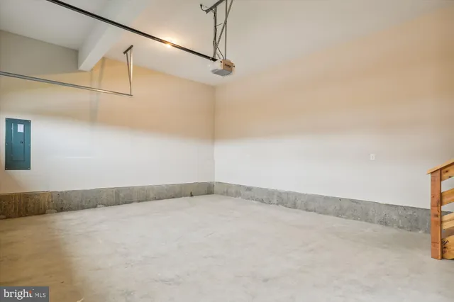 an empty room with a window and wooden floor