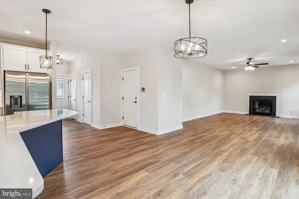 an empty room with a window and wooden floor