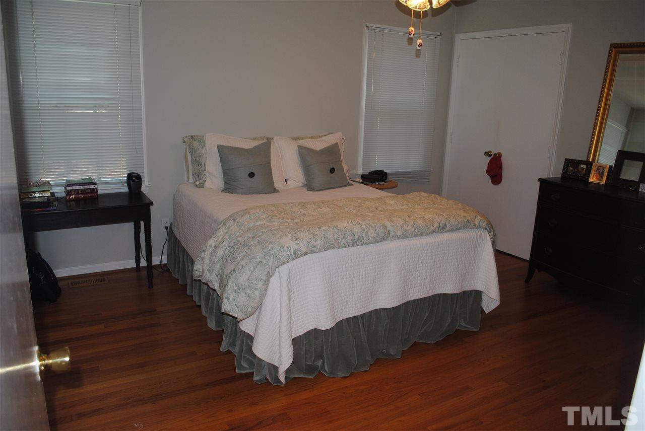 5508 Knollwood Road Raleigh, NC 27609 - Photo 14 of 19 a bedroom with a bed and wooden floor