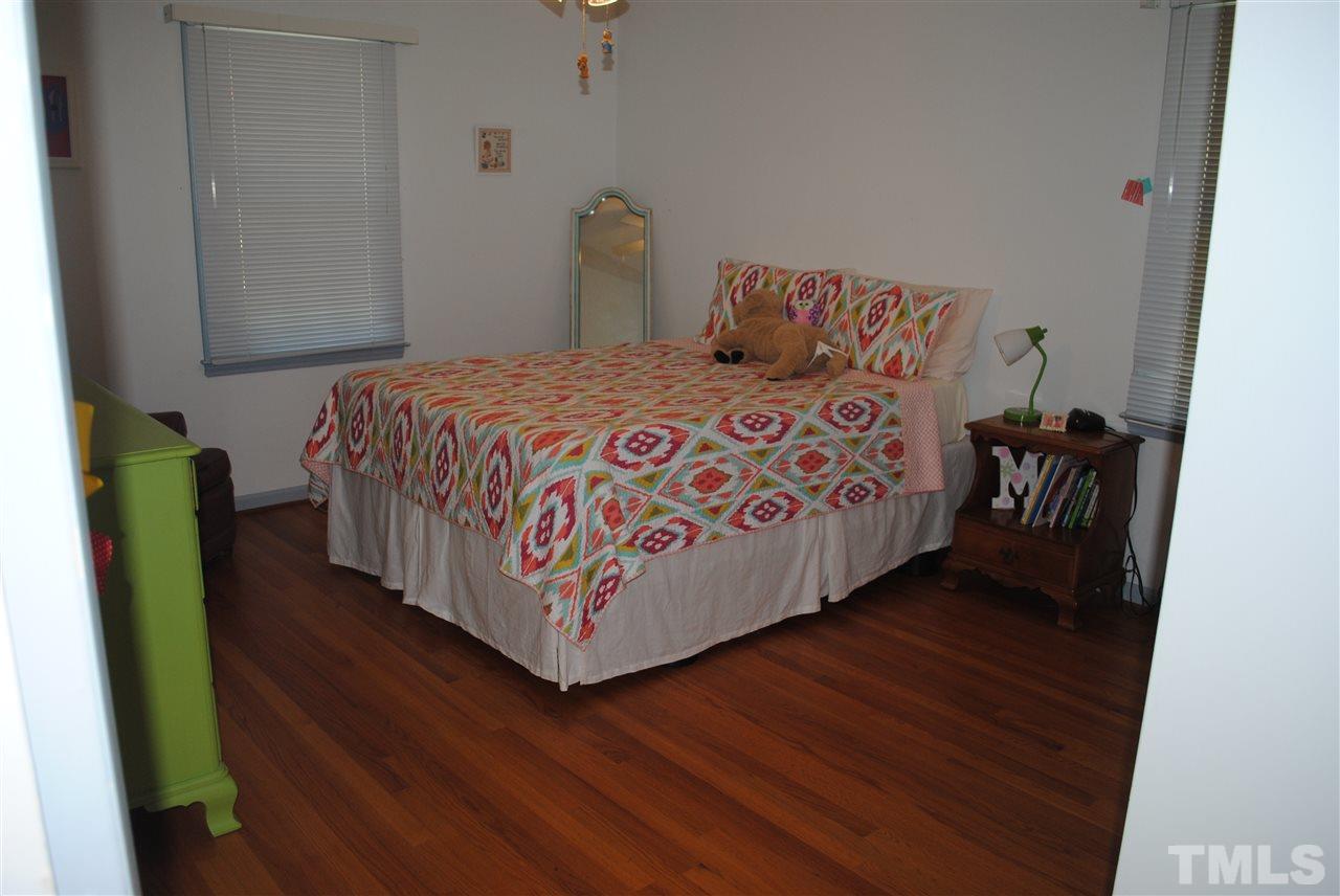 5508 Knollwood Road Raleigh, NC 27609 - Photo 17 of 19 a bedroom with a bed and wooden floor