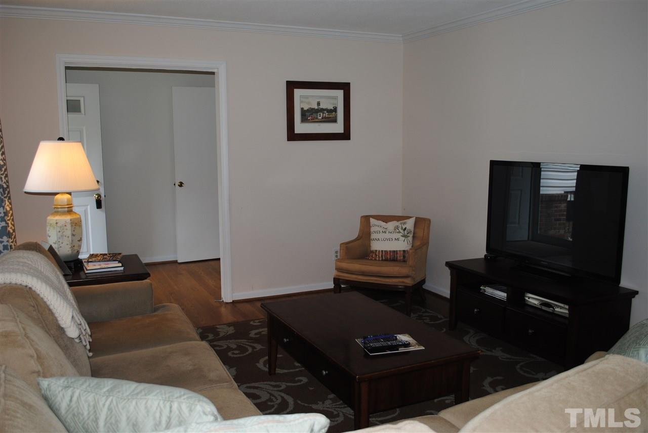 5508 Knollwood Road Raleigh, NC 27609 - Photo 3 of 19 a living room with furniture and a lamp