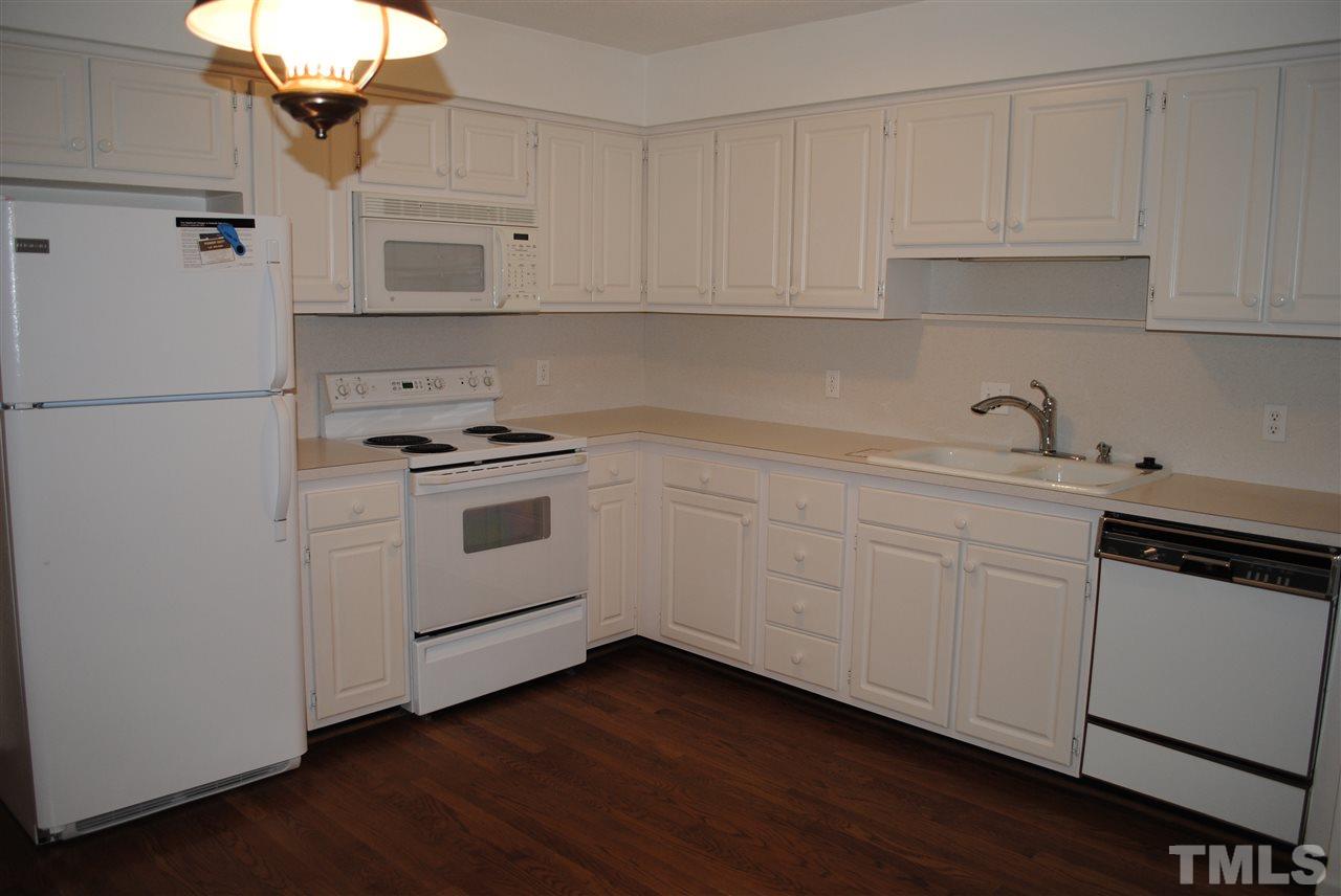 5508 Knollwood Road Raleigh, NC 27609 - Photo 6 of 19 a kitchen with white cabinets and white appliances