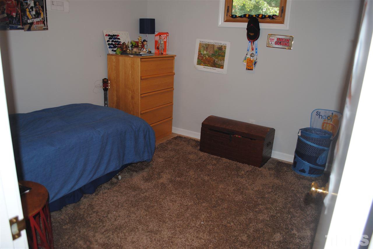 5508 Knollwood Road Raleigh, NC 27609 - Photo 8 of 19 a bedroom with a bed and furniture