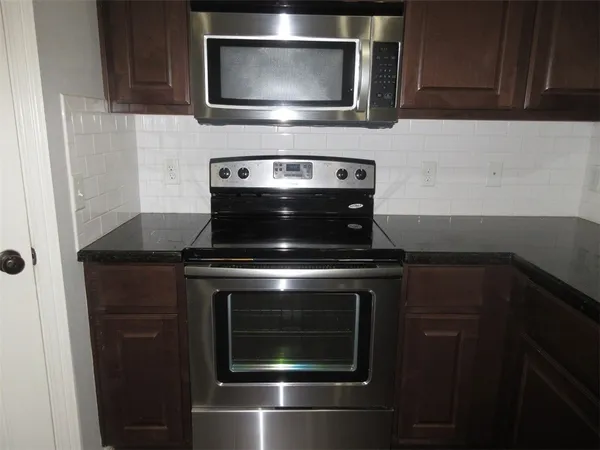 a stove top oven sitting inside of a kitchen