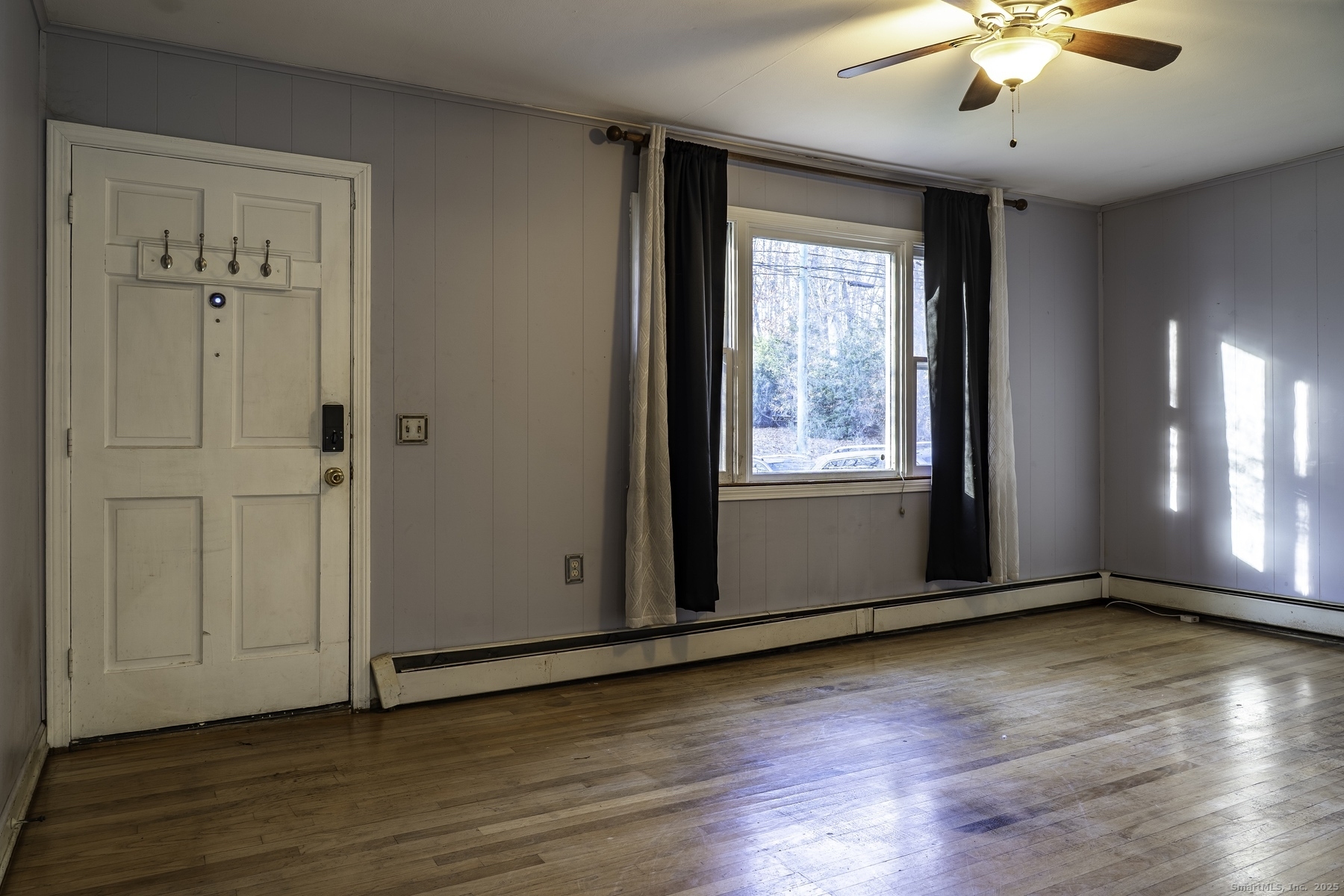 142 Starr Street Norwich, CT 06360 - Photo 13 of 32 a view of an empty room with wooden floor and a window