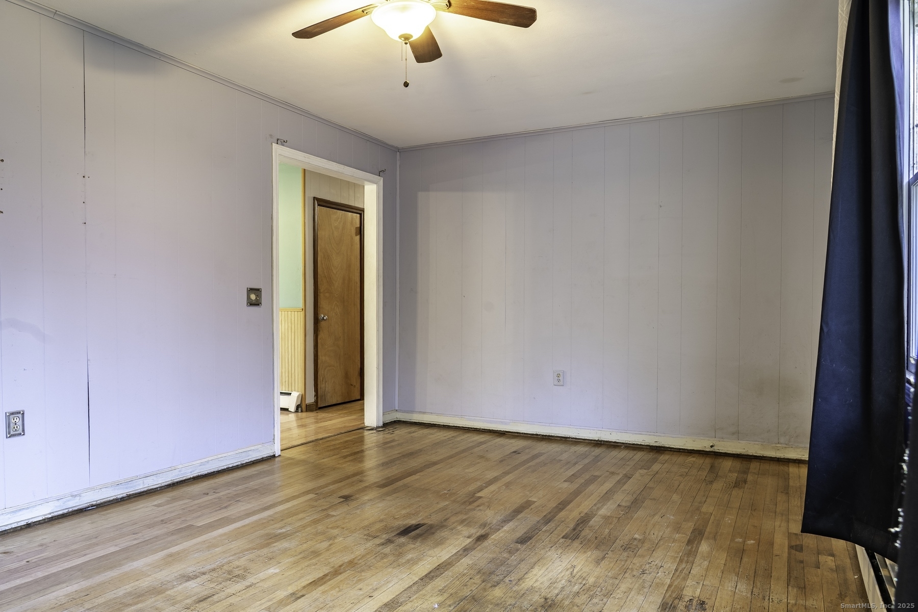 142 Starr Street Norwich, CT 06360 - Photo 15 of 32 an empty room with wooden floor and chandelier fan
