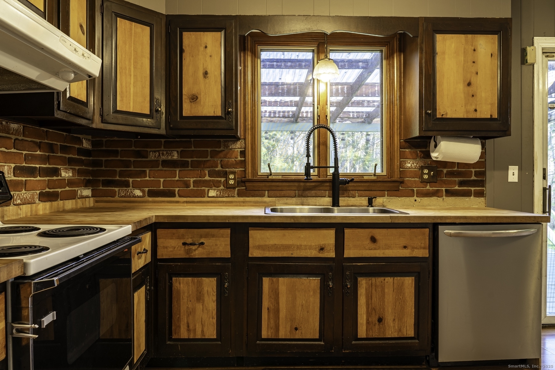 142 Starr Street Norwich, CT 06360 - Photo 18 of 32 a kitchen with a window a sink and cabinets