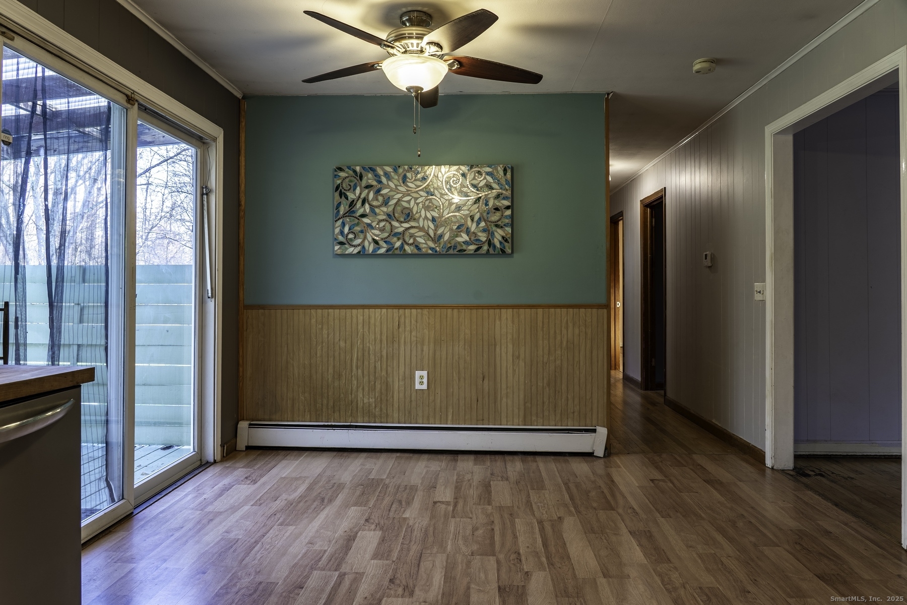 142 Starr Street Norwich, CT 06360 - Photo 19 of 32 an empty room with wooden floor chandelier fan and windows