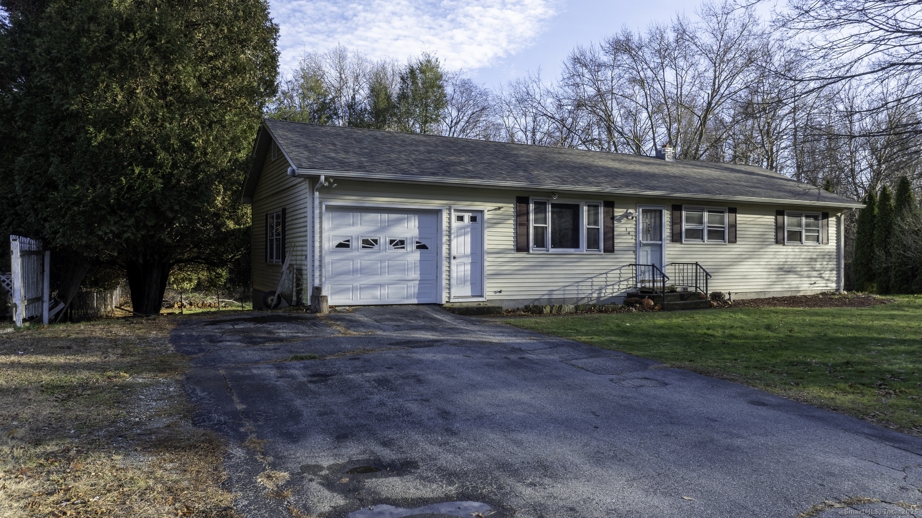 142 Starr Street Norwich, CT 06360 - Photo 2 of 32 a front view of a house with a garden and trees