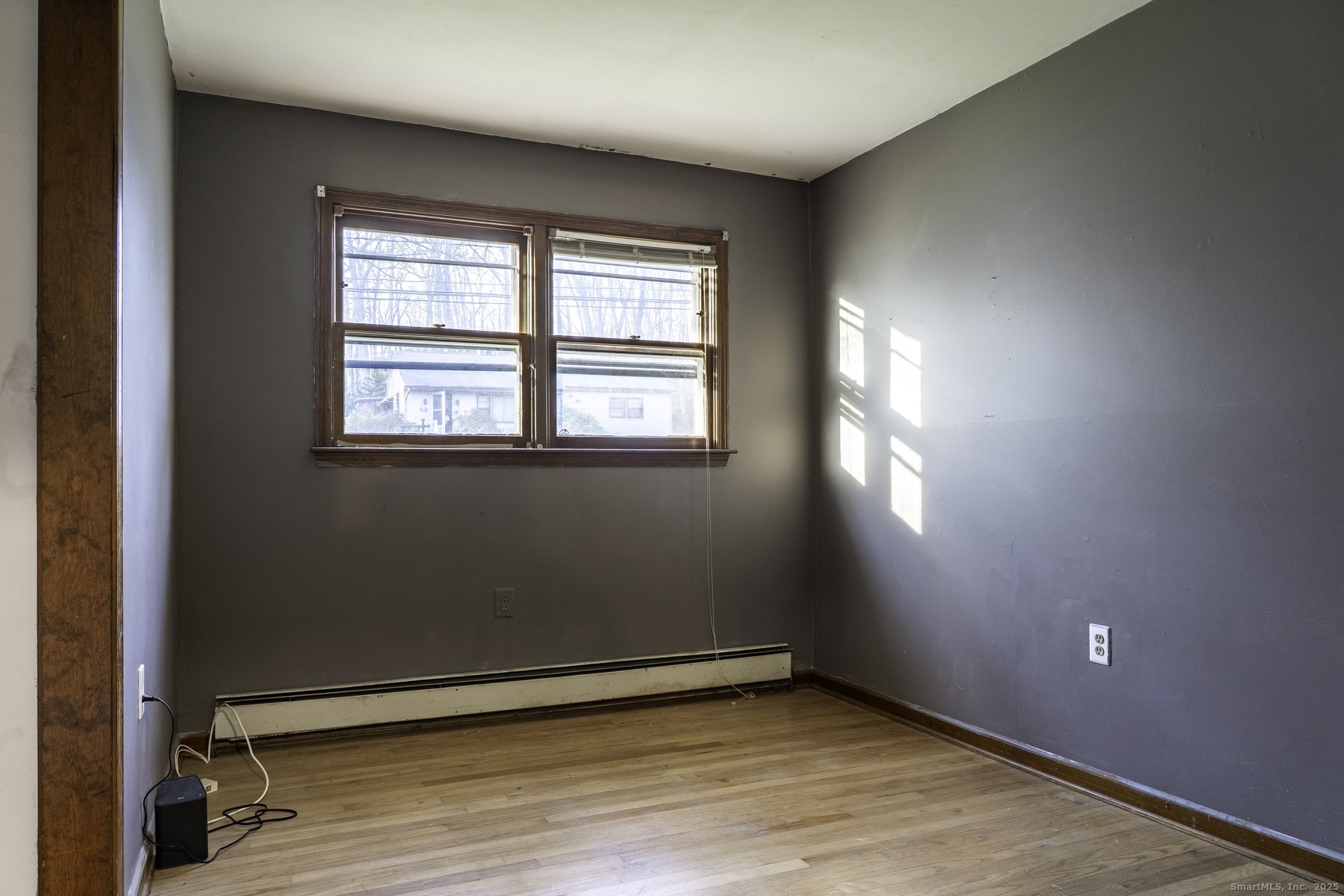 142 Starr Street Norwich, CT 06360 - Photo 22 of 32 an empty room with wooden floor and windows