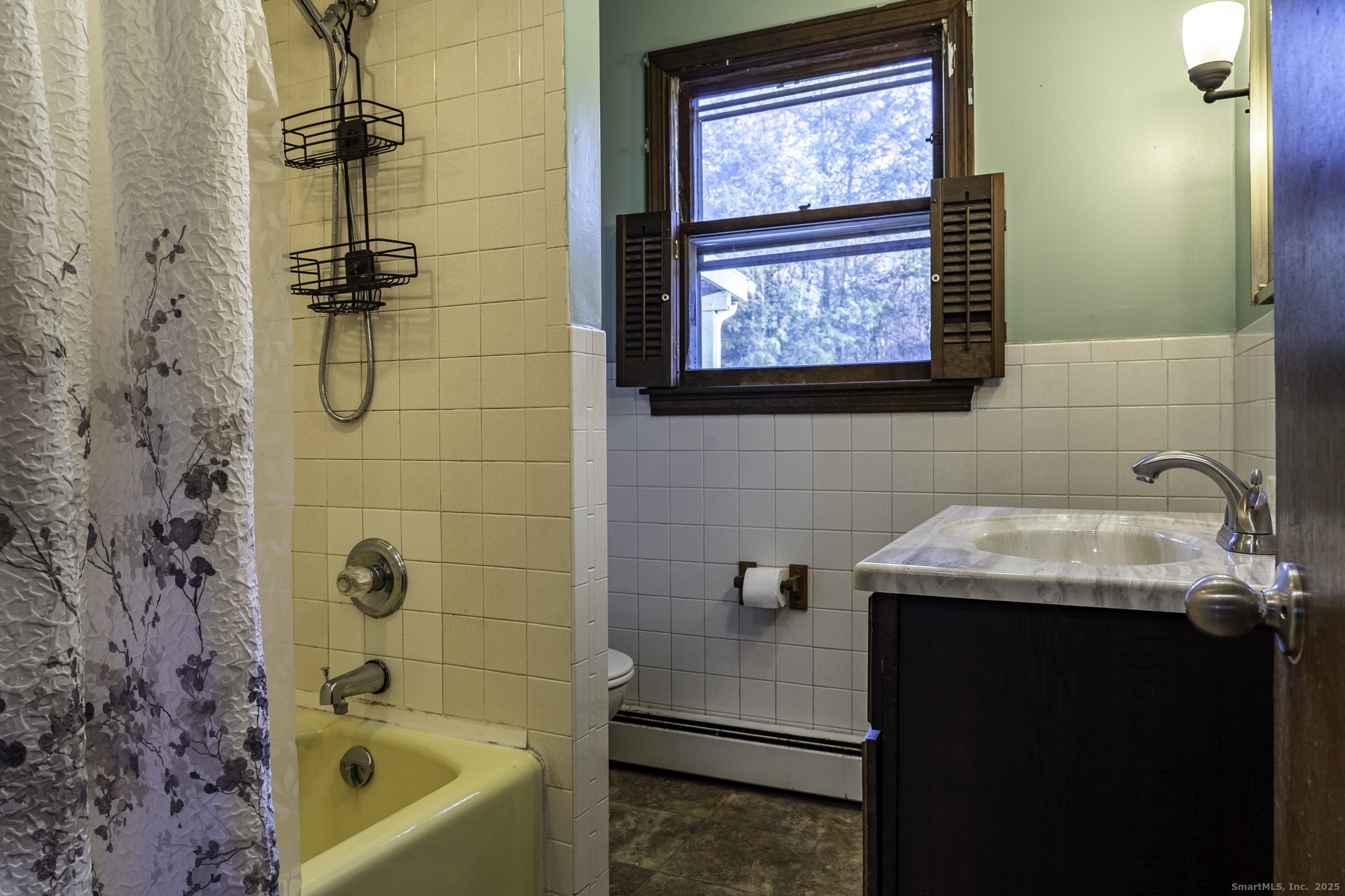 142 Starr Street Norwich, CT 06360 - Photo 24 of 32 a bathroom with a bath tub a sink and a window