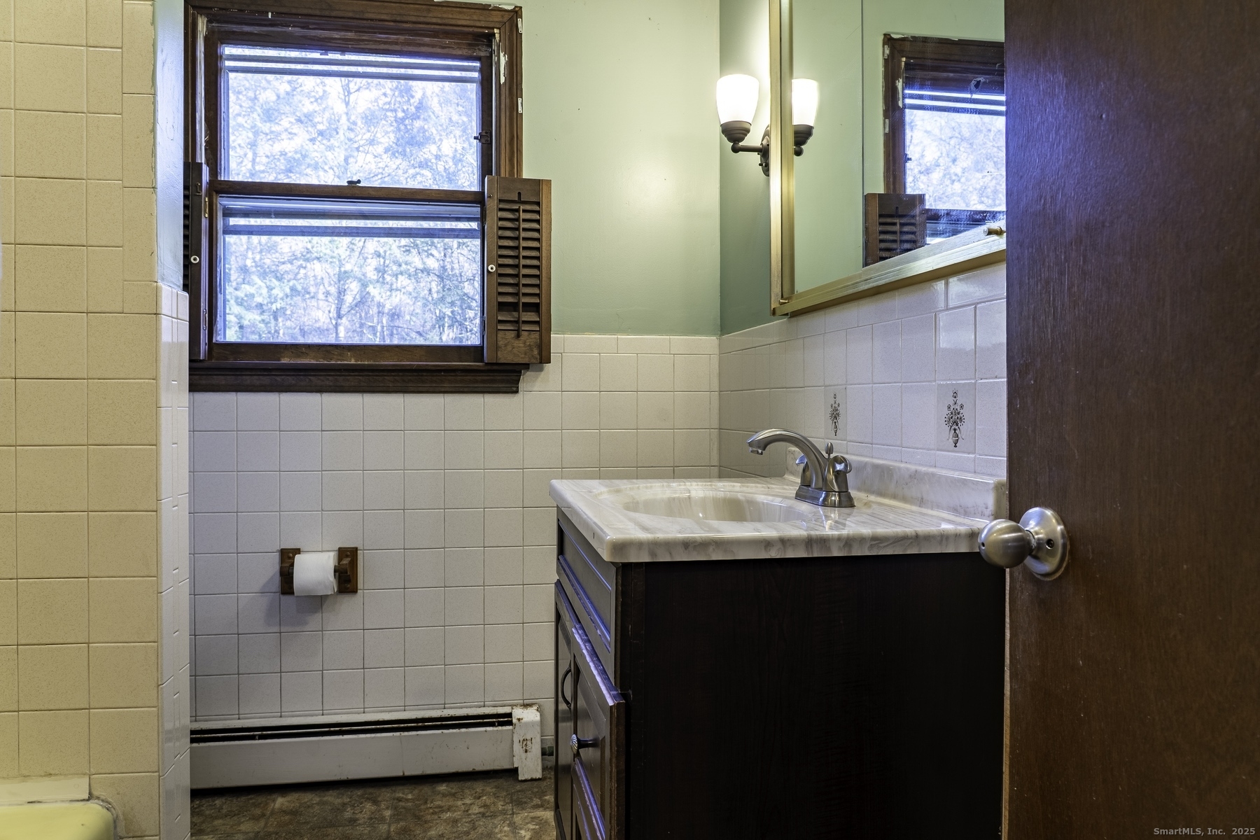142 Starr Street Norwich, CT 06360 - Photo 25 of 32 a bathroom with a sink and a mirror
