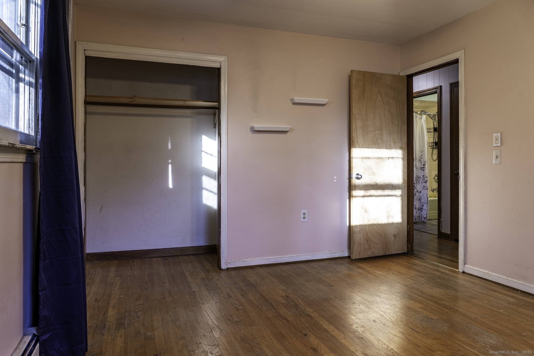 142 Starr Street Norwich, CT 06360 - Photo 27 of 32 an empty room with wooden floor and windows