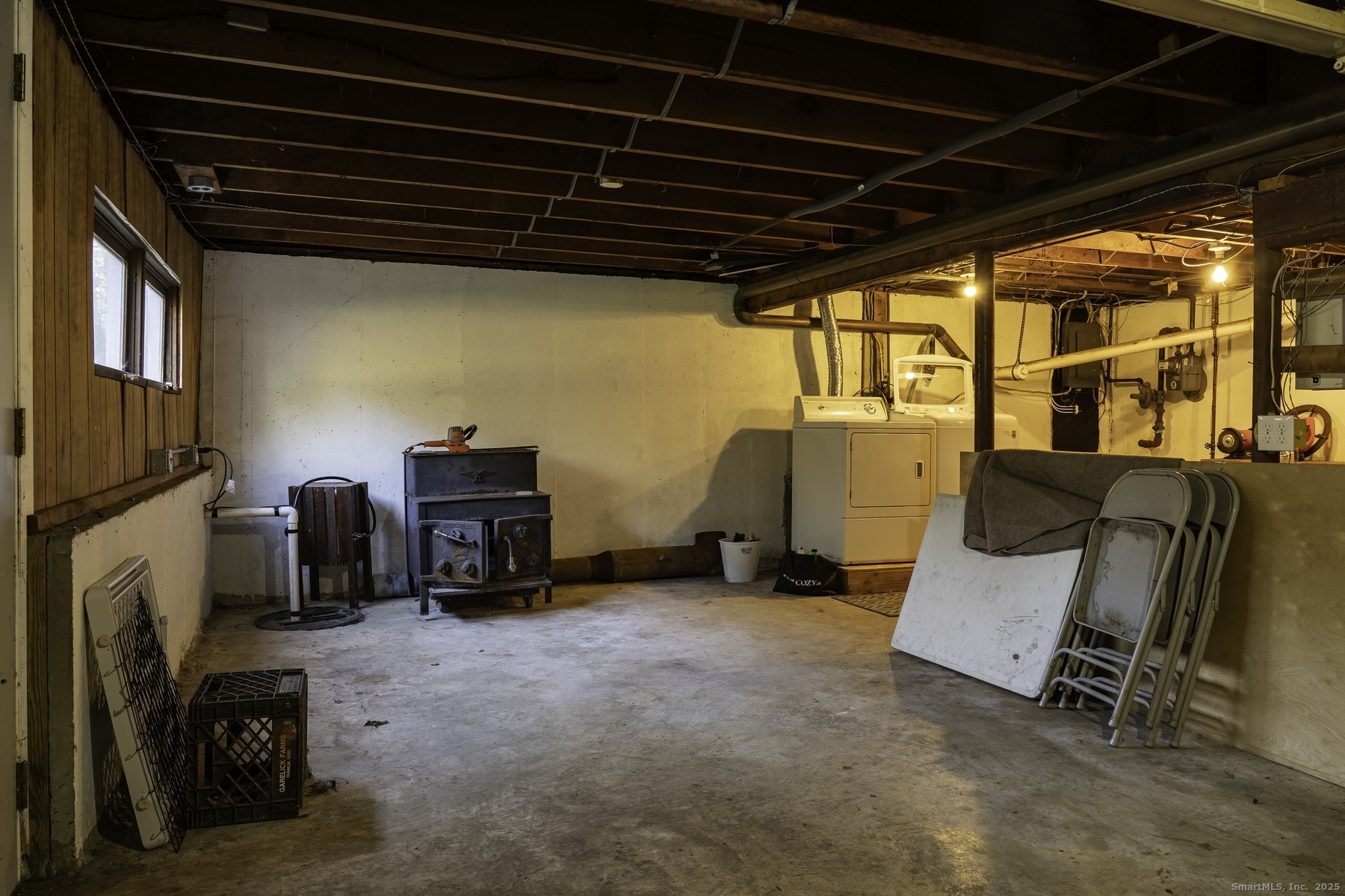 142 Starr Street Norwich, CT 06360 - Photo 32 of 32 a view of a storage room with furniture and a fireplace