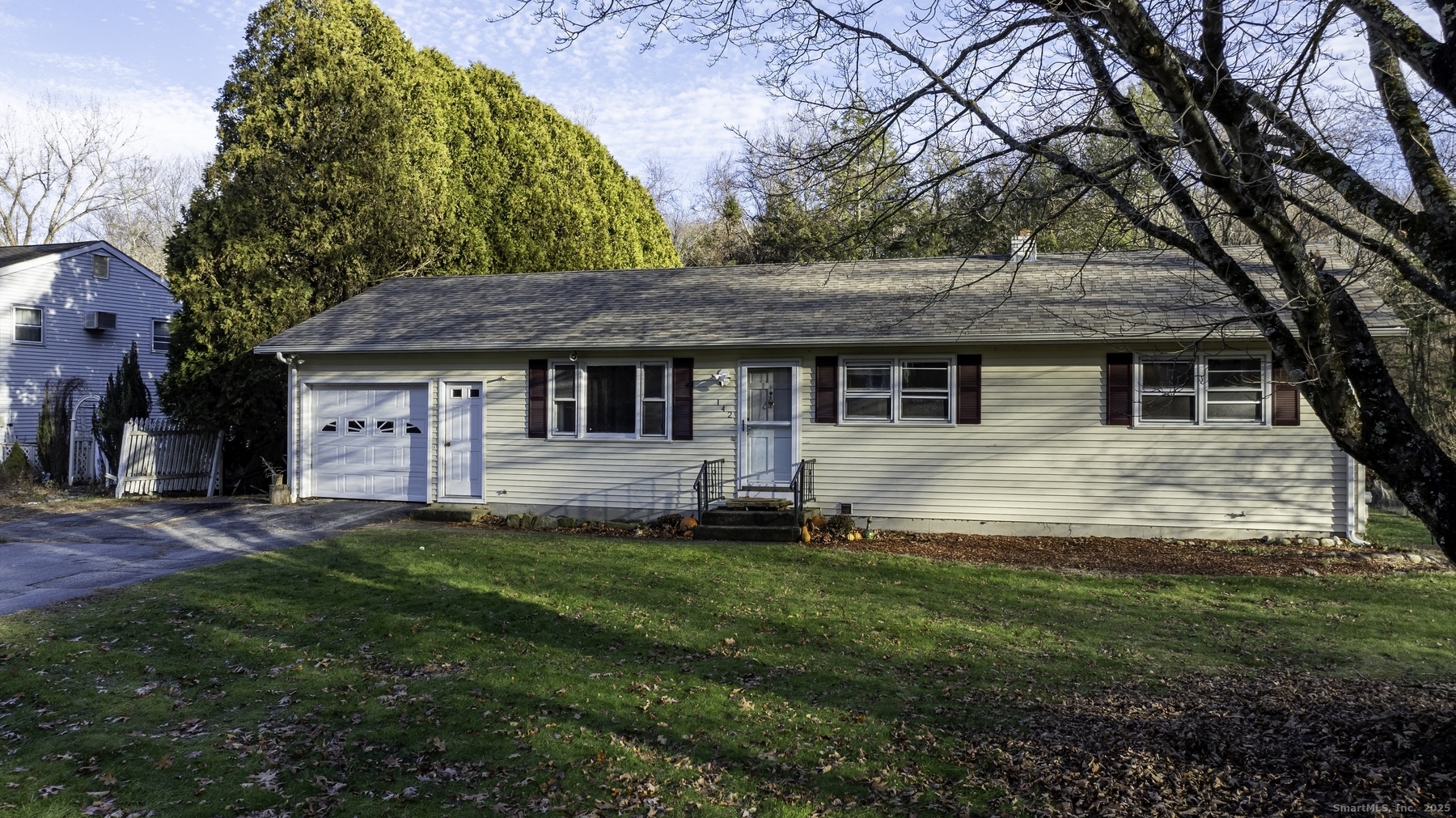 142 Starr Street Norwich, CT 06360 - Photo 4 of 32 a front view of a house with a garden and trees