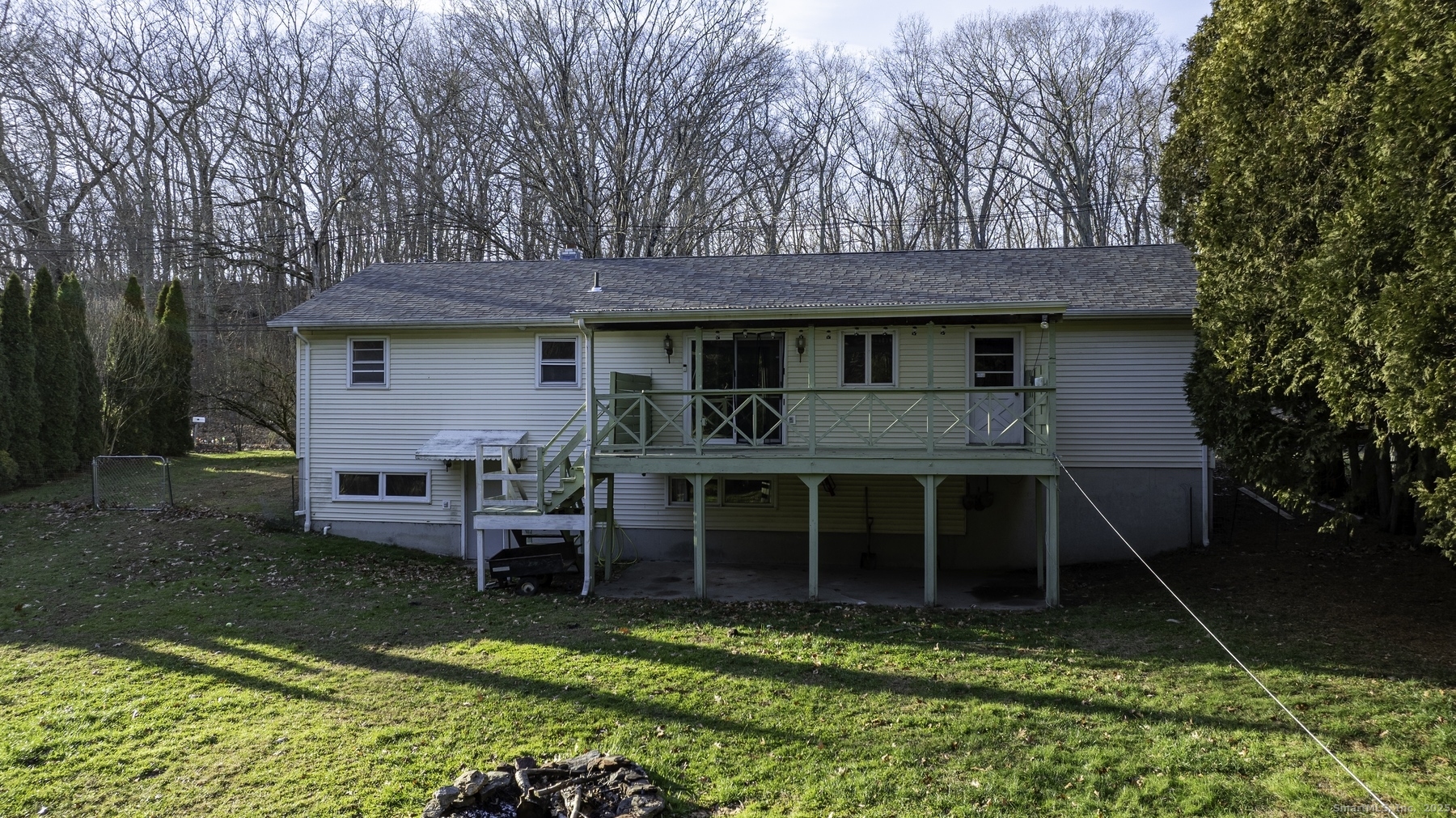 142 Starr Street Norwich, CT 06360 - Photo 8 of 32 a view of a house with a yard potted plants and a table