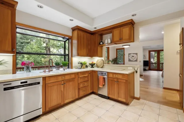 a kitchen counter with sink and window