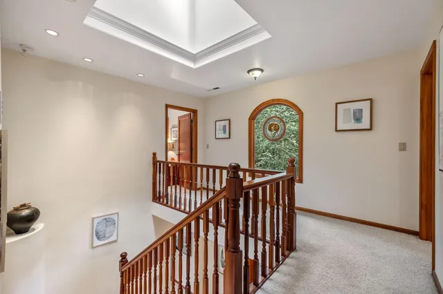 a spacious bedroom with a bed and a large window