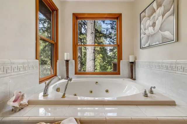 a living room with furniture and a wall painting