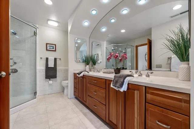 a bathroom with a double vanity sink and a mirror