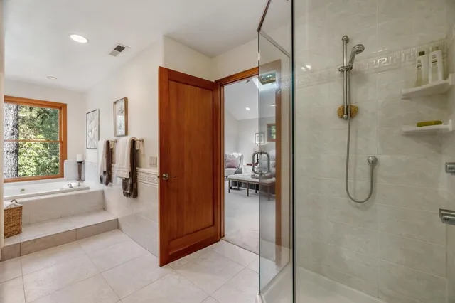 a bathroom with a tub shower and a sink