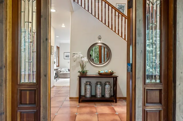 a living room with furniture large window and a flat screen tv